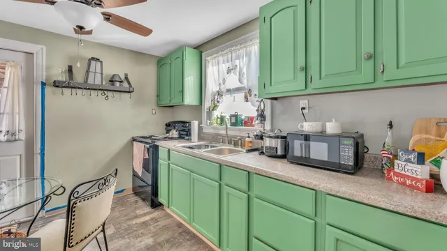 a kitchen with a refrigerator and a stove