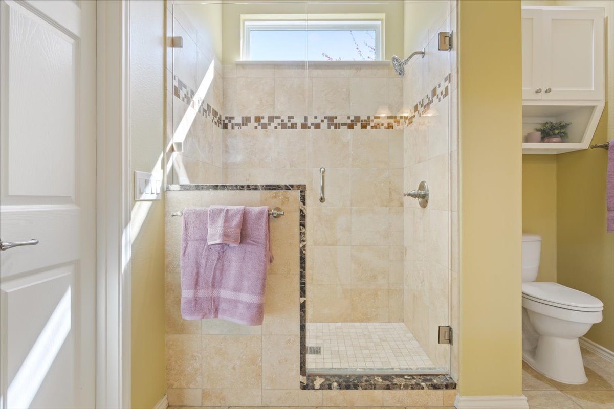 113 Sunny Side Bend Georgetown, TX 78633 - Photo 22 of 33 Tiled shower with glass door is a nice upgrade feature.