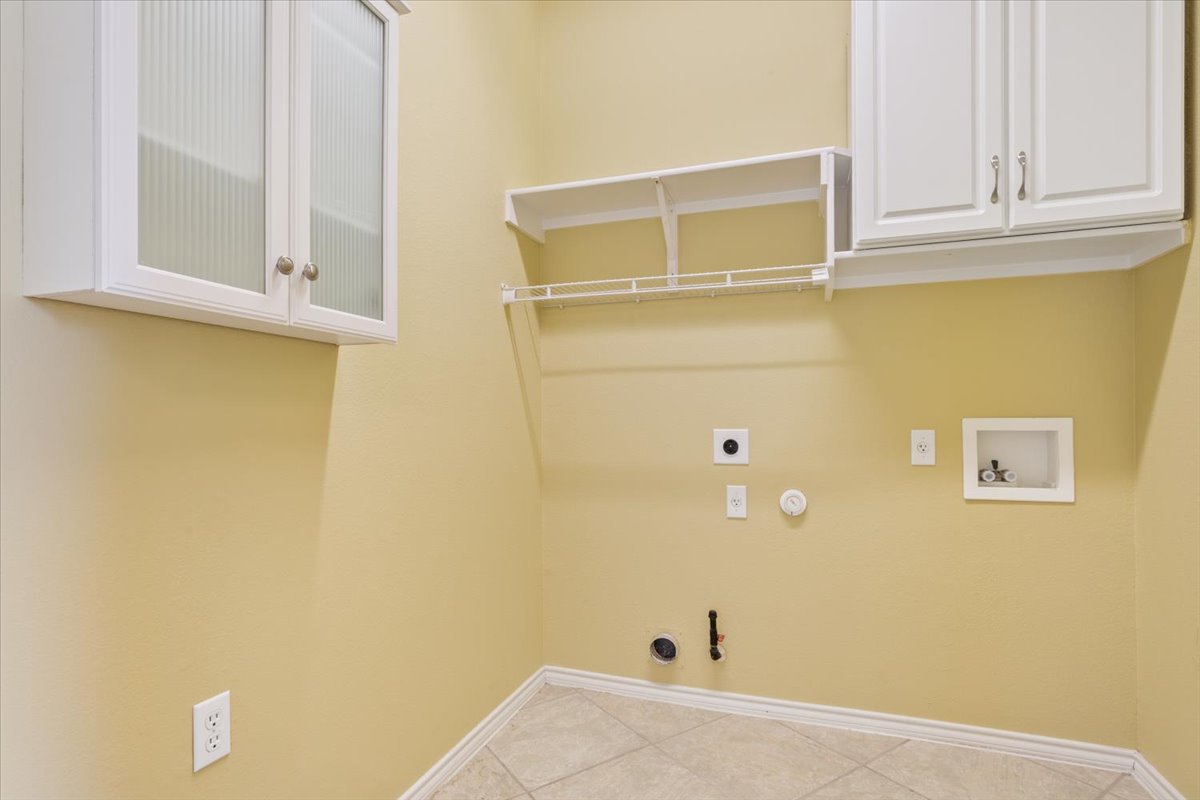 113 Sunny Side Bend Georgetown, TX 78633 - Photo 31 of 33 Laundry room has electric or gas connection for dryer along with storage cabinets.