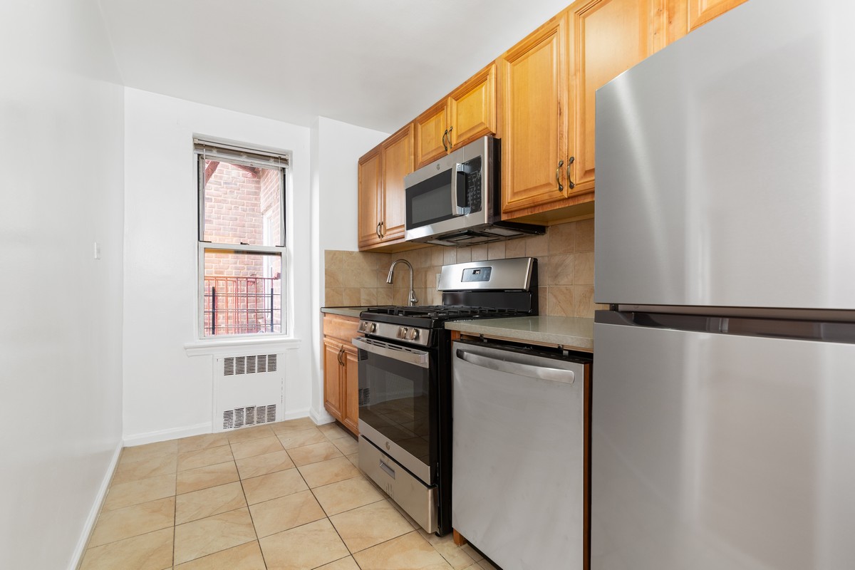 a kitchen with stainless steel appliances a refrigerator stove and microwave