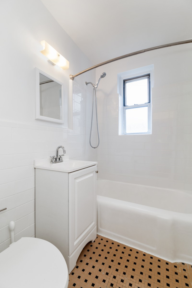 67-07 Yellowstone Boulevard, Unit 5G Queens, NY 11375 - Photo 6 of 7 a bathroom with a sink a toilet and shower