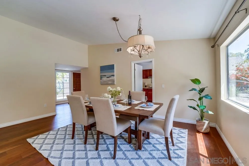 7214 Durango Circle Carlsbad, CA 92011 - Photo 11 of 37 a view of a dining room with furniture window and wooden floor