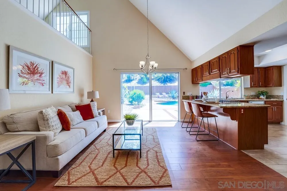 7214 Durango Circle Carlsbad, CA 92011 - Photo 14 of 37 a living room with furniture a dining table and a large window