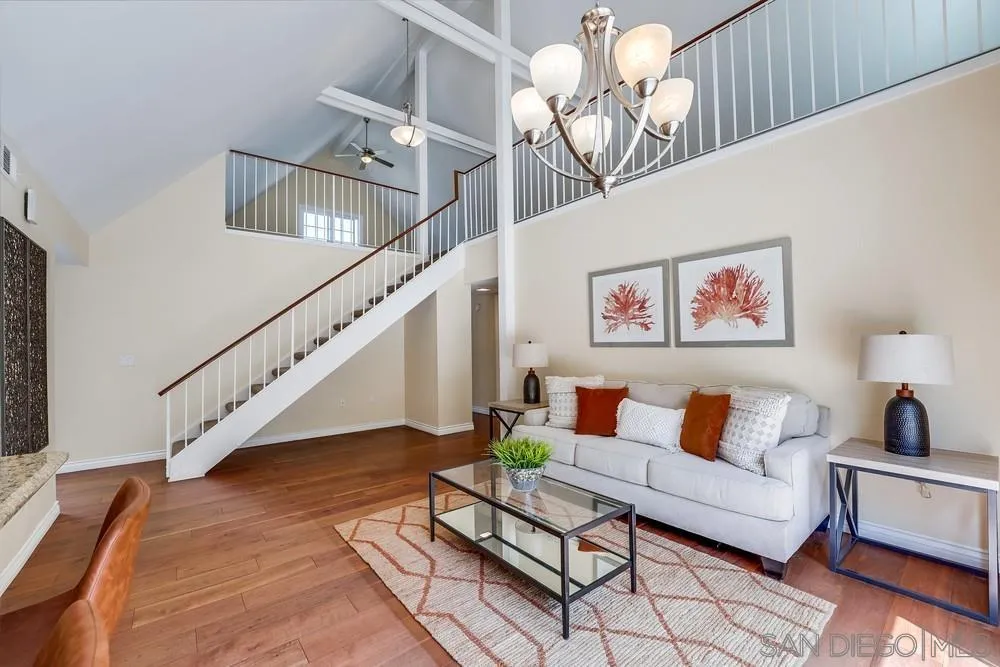 7214 Durango Circle Carlsbad, CA 92011 - Photo 17 of 37 a living room with furniture chandelier and a rug