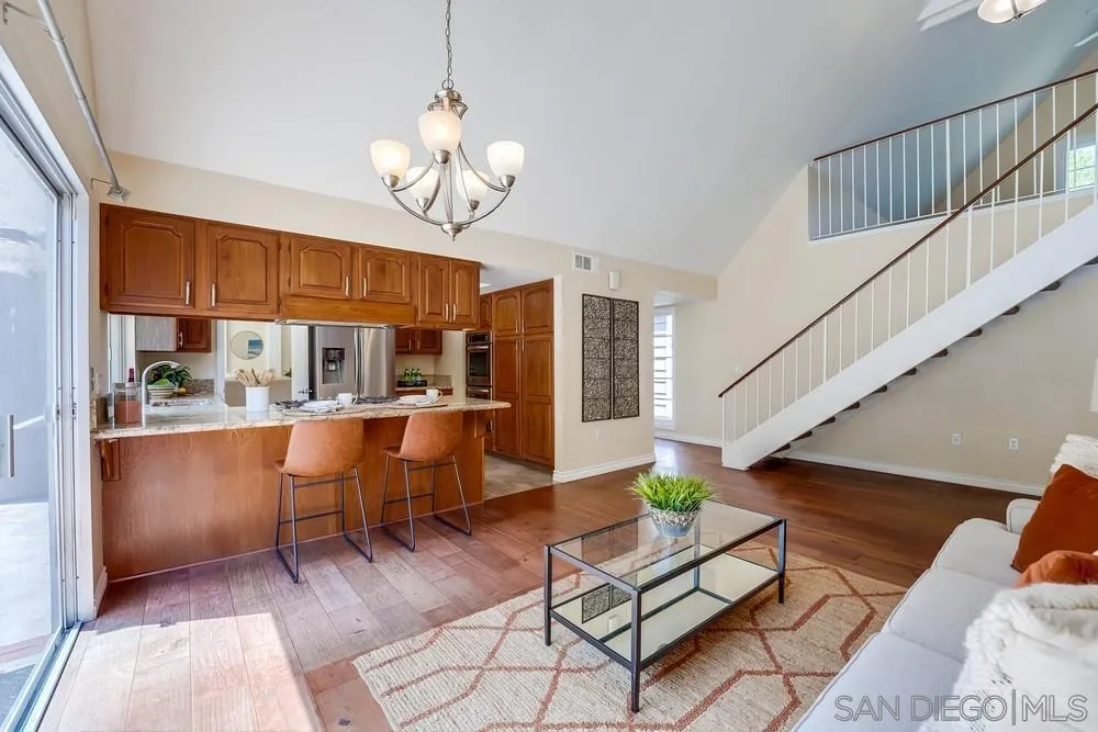 7214 Durango Circle Carlsbad, CA 92011 - Photo 18 of 37 a view of dining room filled with furniture and wooden floor