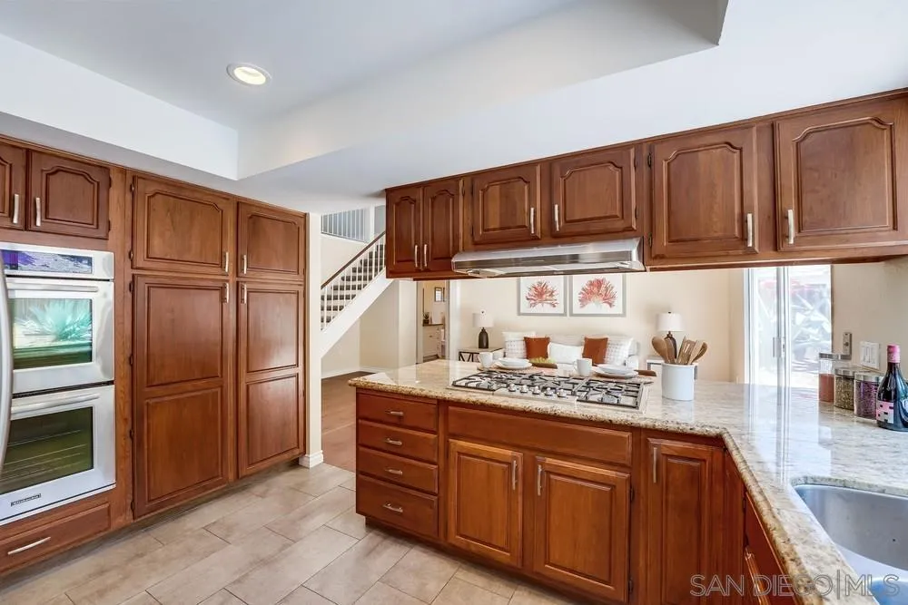 7214 Durango Circle Carlsbad, CA 92011 - Photo 22 of 37 a kitchen with stainless steel appliances granite countertop a refrigerator and cabinets