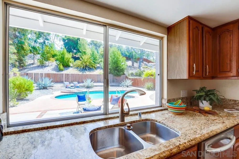7214 Durango Circle Carlsbad, CA 92011 - Photo 23 of 37 a kitchen with a sink a counter and a large window