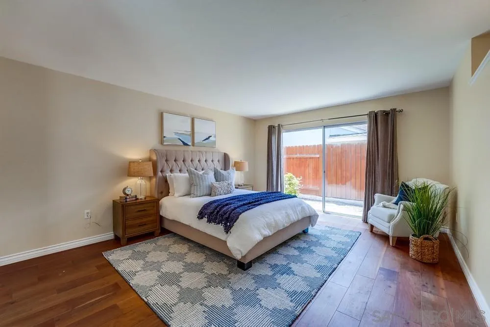7214 Durango Circle Carlsbad, CA 92011 - Photo 28 of 37 a spacious bedroom with a bed and a potted plant