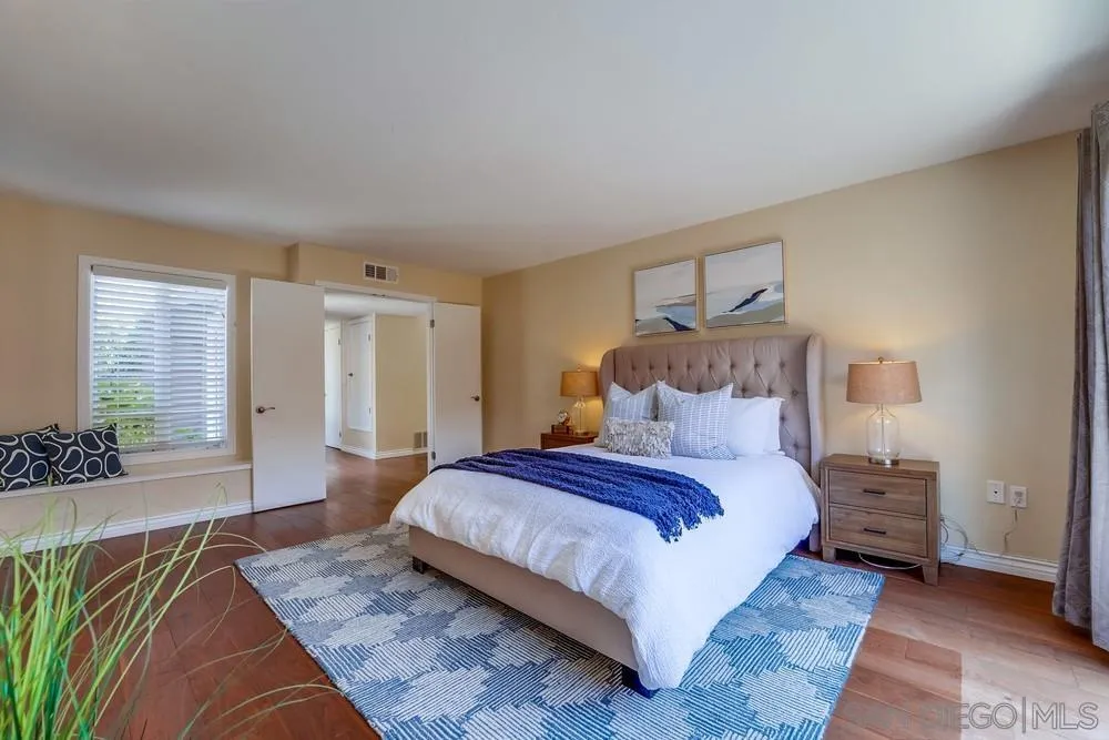 7214 Durango Circle Carlsbad, CA 92011 - Photo 29 of 37 a bedroom with a large bed and a couch