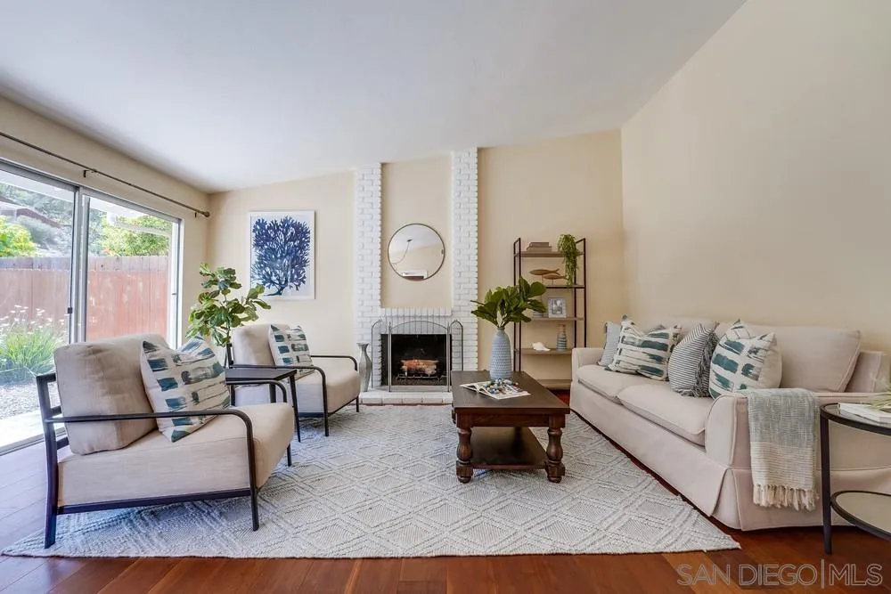 7214 Durango Circle Carlsbad, CA 92011 - Photo 3 of 37 a living room with furniture a fireplace and a potted plant