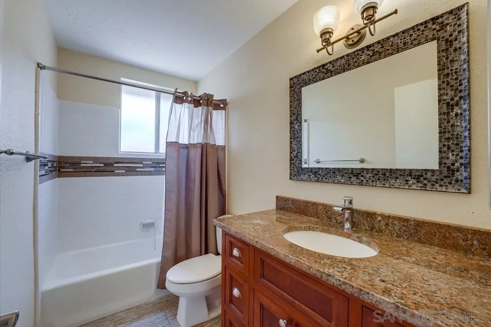 7214 Durango Circle Carlsbad, CA 92011 - Photo 32 of 37 a bathroom with a granite countertop sink toilet and shower