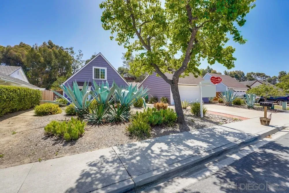 7214 Durango Circle Carlsbad, CA 92011 - Photo 5 of 37 a front view of a house with a yard and a garage