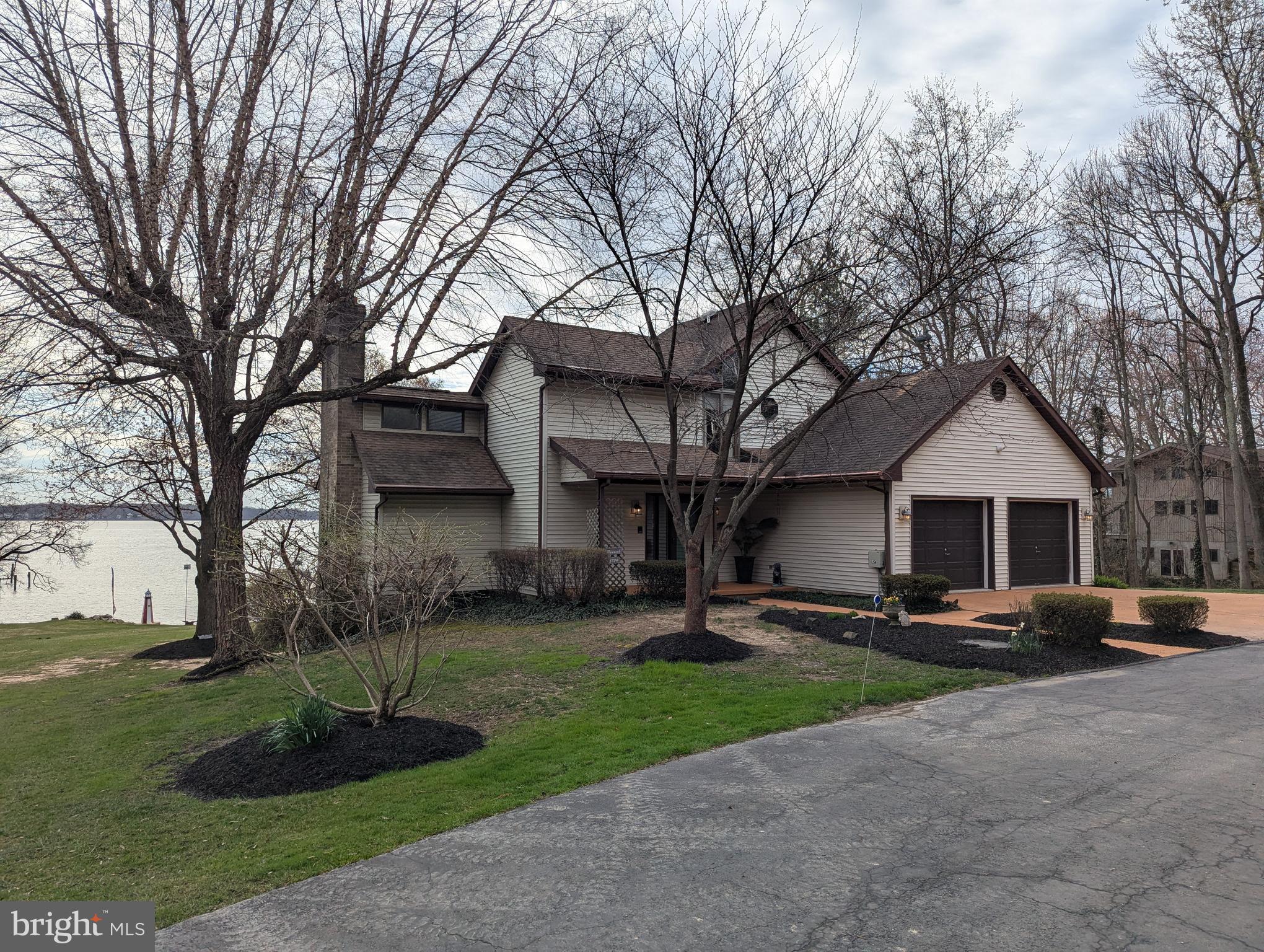 3729 Abingdon Beach Road Abingdon, MD 21009 - Photo 2 of 85 a front view of a house with a yard and trees