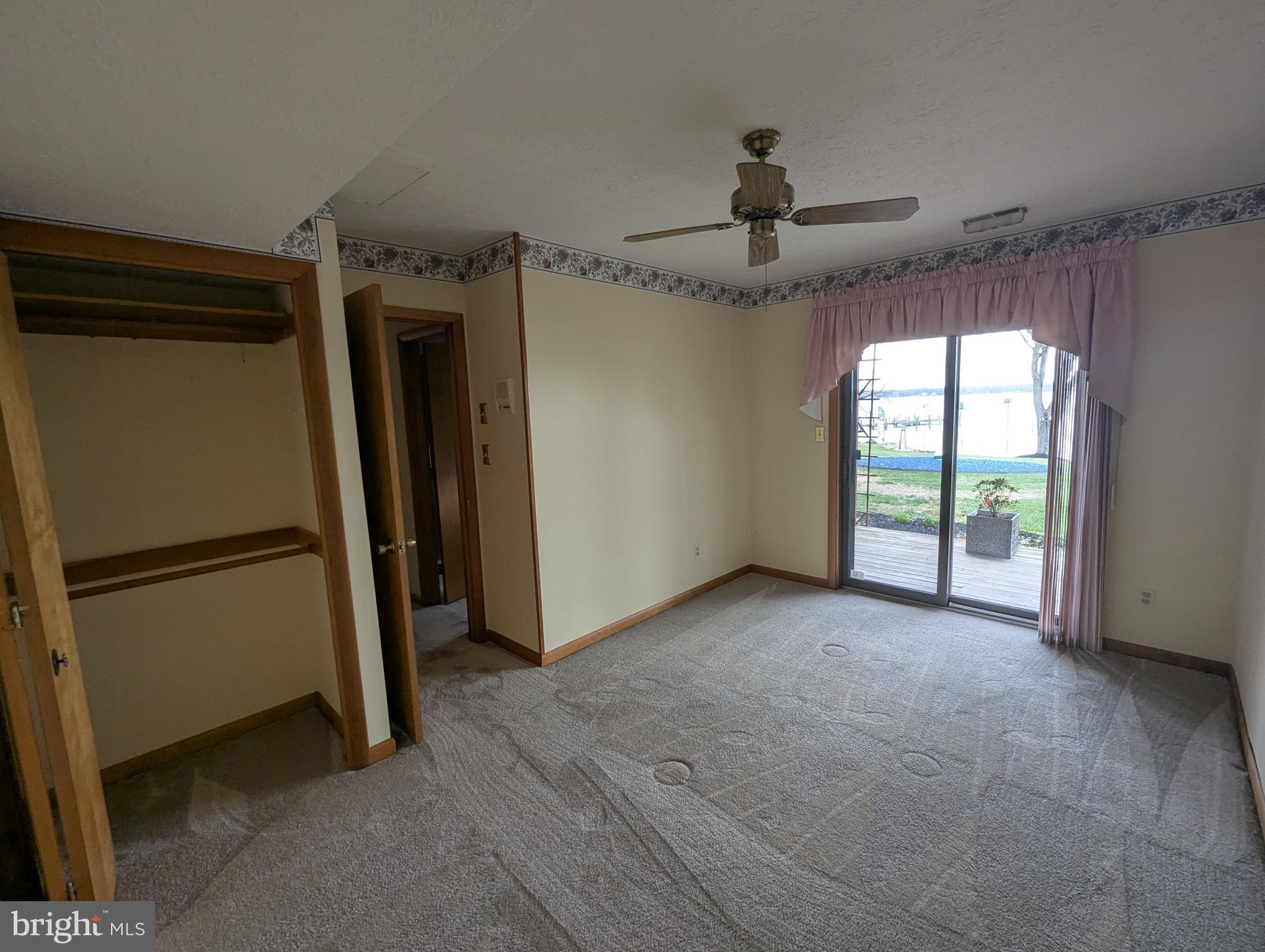 3729 Abingdon Beach Road Abingdon, MD 21009 - Photo 56 of 85 a view of a livingroom with a ceiling fan window and a kitchen space