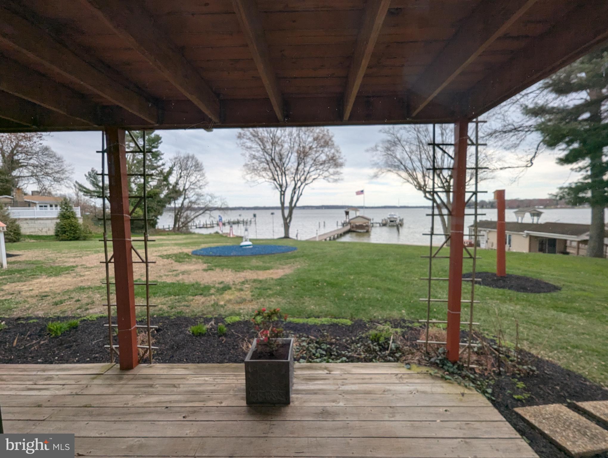 3729 Abingdon Beach Road Abingdon, MD 21009 - Photo 61 of 85 a view of a patio with a table chairs and a yard