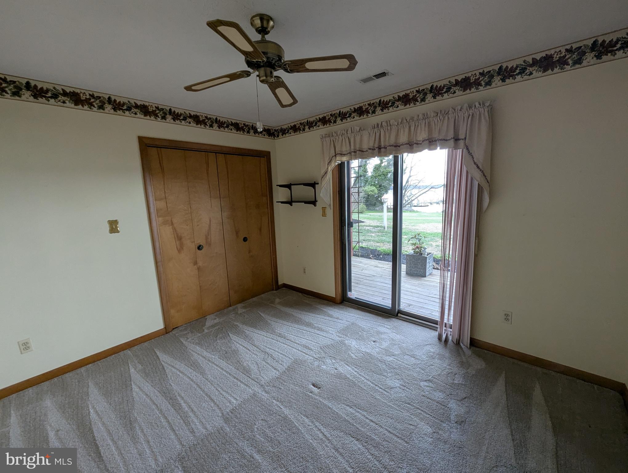 3729 Abingdon Beach Road Abingdon, MD 21009 - Photo 80 of 85 a view of a livingroom with a hardwood floor and a ceiling fan