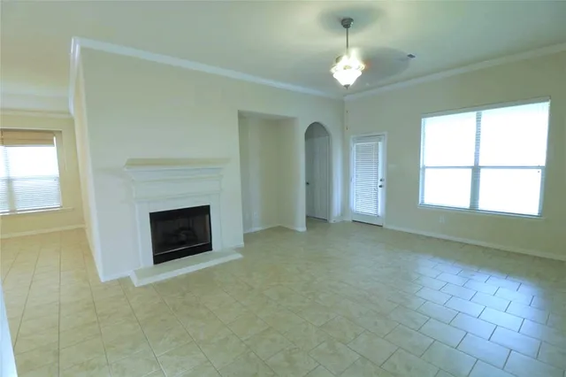 a view of empty room with a fireplace and window