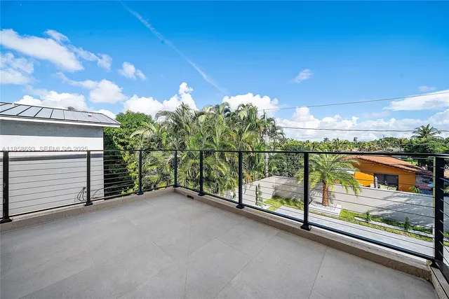 a white bath tub sitting in a spacious bathroom next to a window