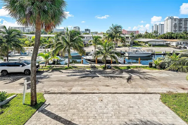 an aerial view of a house with a yard and lake view