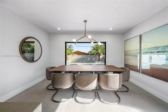 a large kitchen with kitchen island a large counter top space a sink stainless steel appliances and cabinets