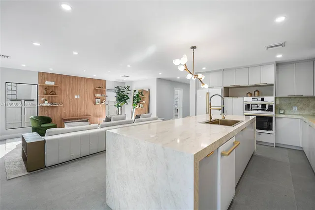 a living room with fireplace furniture and a large window