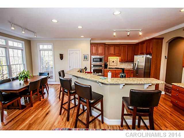 3413 Rhett Butler Place Charlotte, NC 28270 - Photo 3 of 15 a open dining room with stainless steel appliances kitchen island granite countertop a dining table chairs and granite counter tops
