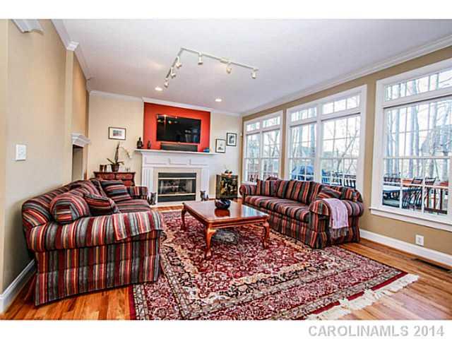 3413 Rhett Butler Place Charlotte, NC 28270 - Photo 6 of 15 a living room with furniture a flat screen tv and a fireplace