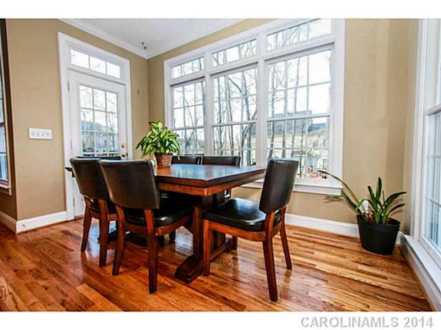 3413 Rhett Butler Place Charlotte, NC 28270 - Photo 8 of 15 a dining room with furniture potted plants and wooden floor