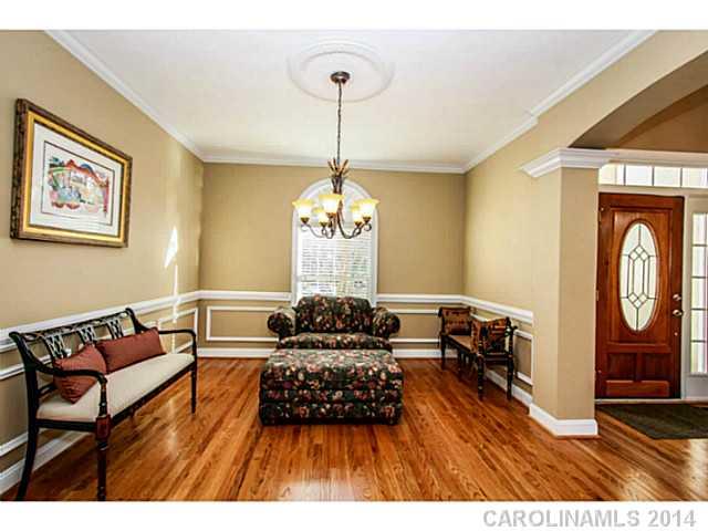 3413 Rhett Butler Place Charlotte, NC 28270 - Photo 9 of 15 a living room with furniture and a chandelier