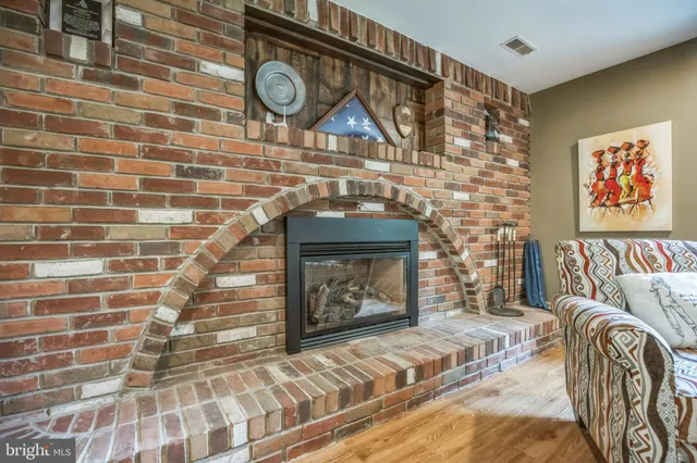 a bedroom with a bed and a fireplace