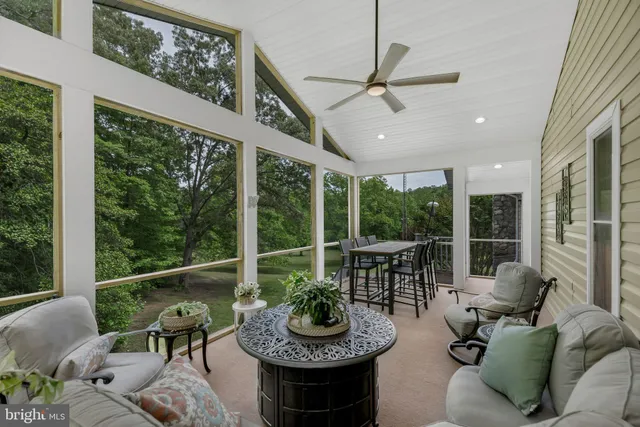 a living room with furniture and a floor to ceiling windows