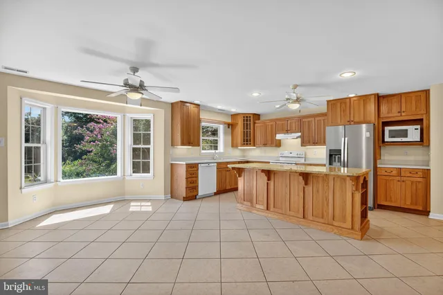 a view of kitchen with windows and refrigerator