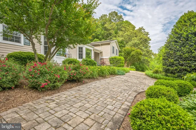 a front view of a house with a yard and potted plants