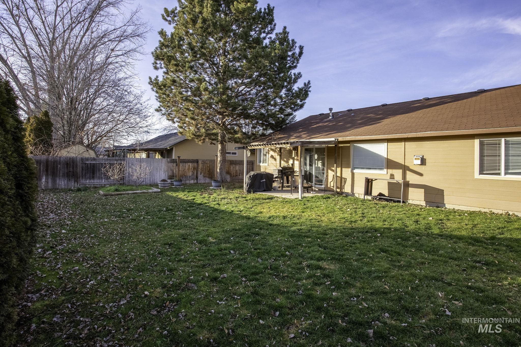 7899 West Prince Street Boise, ID 83714 - Photo 13 of 15 Rear view of property with a patio and a fenced backyard