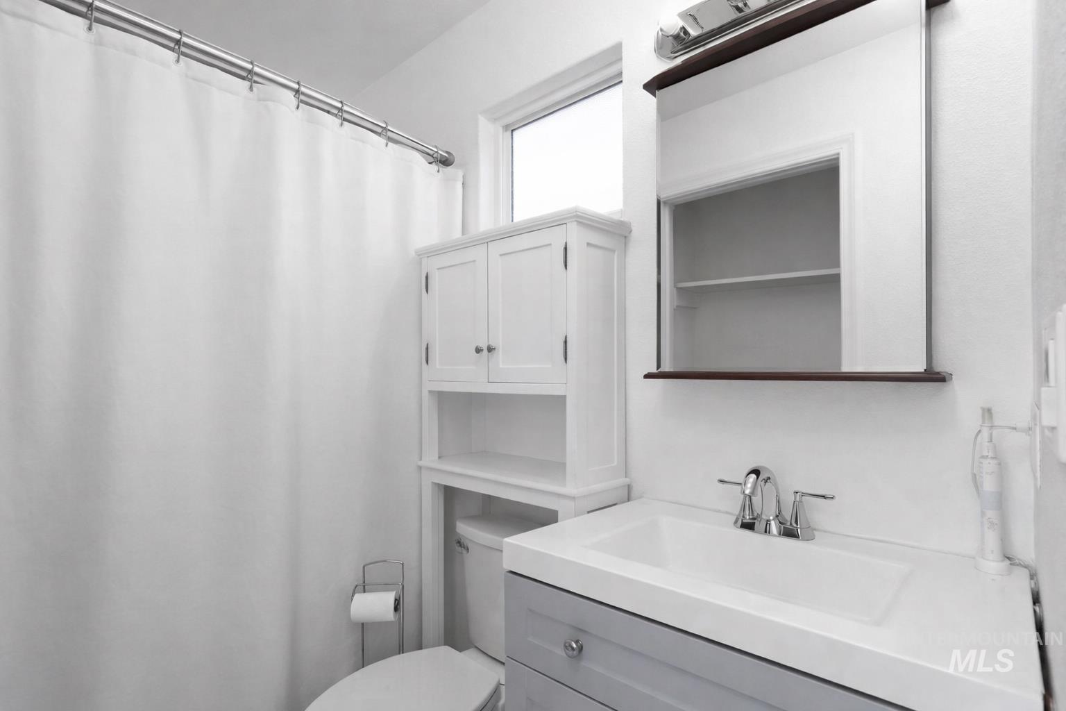 7899 West Prince Street Boise, ID 83714 - Photo 8 of 15 Full bath with a shower with shower curtain and vanity