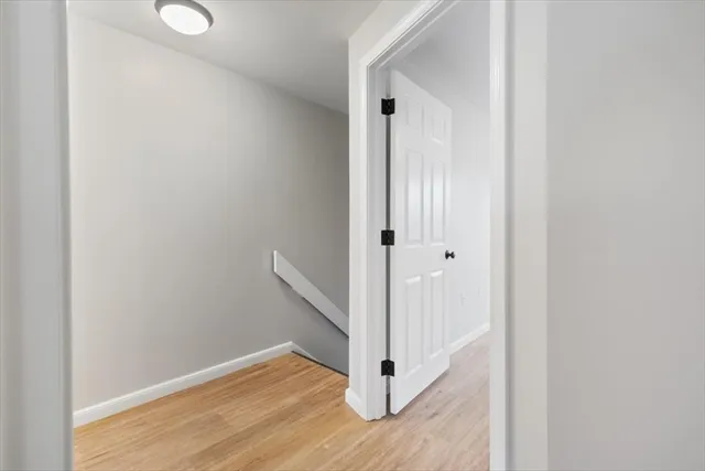 a view of a room with wooden floor and windows