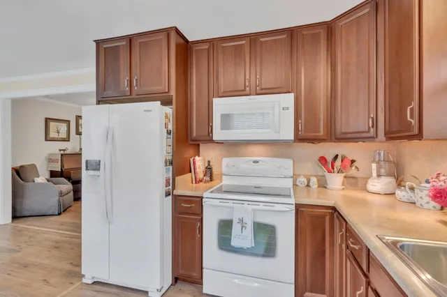 a kitchen with stainless steel appliances granite countertop a refrigerator sink and cabinets