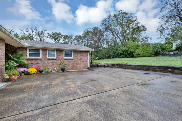 a view of an house with backyard space and garden