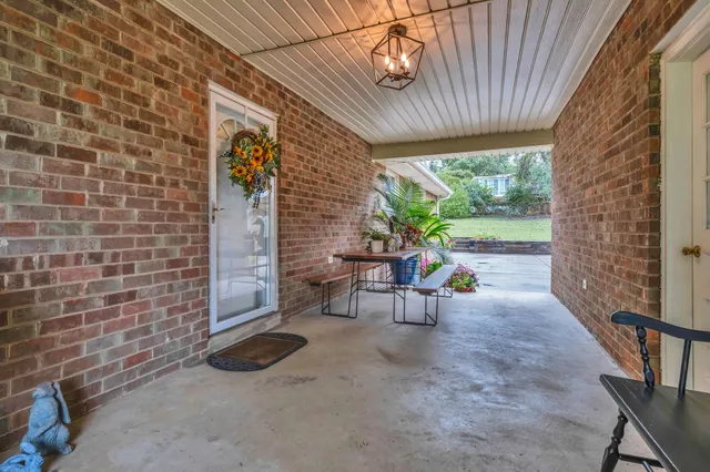 a view of a patio with table and chairs and potted plants