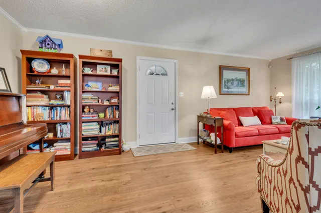 a bedroom with furniture and a book shelf