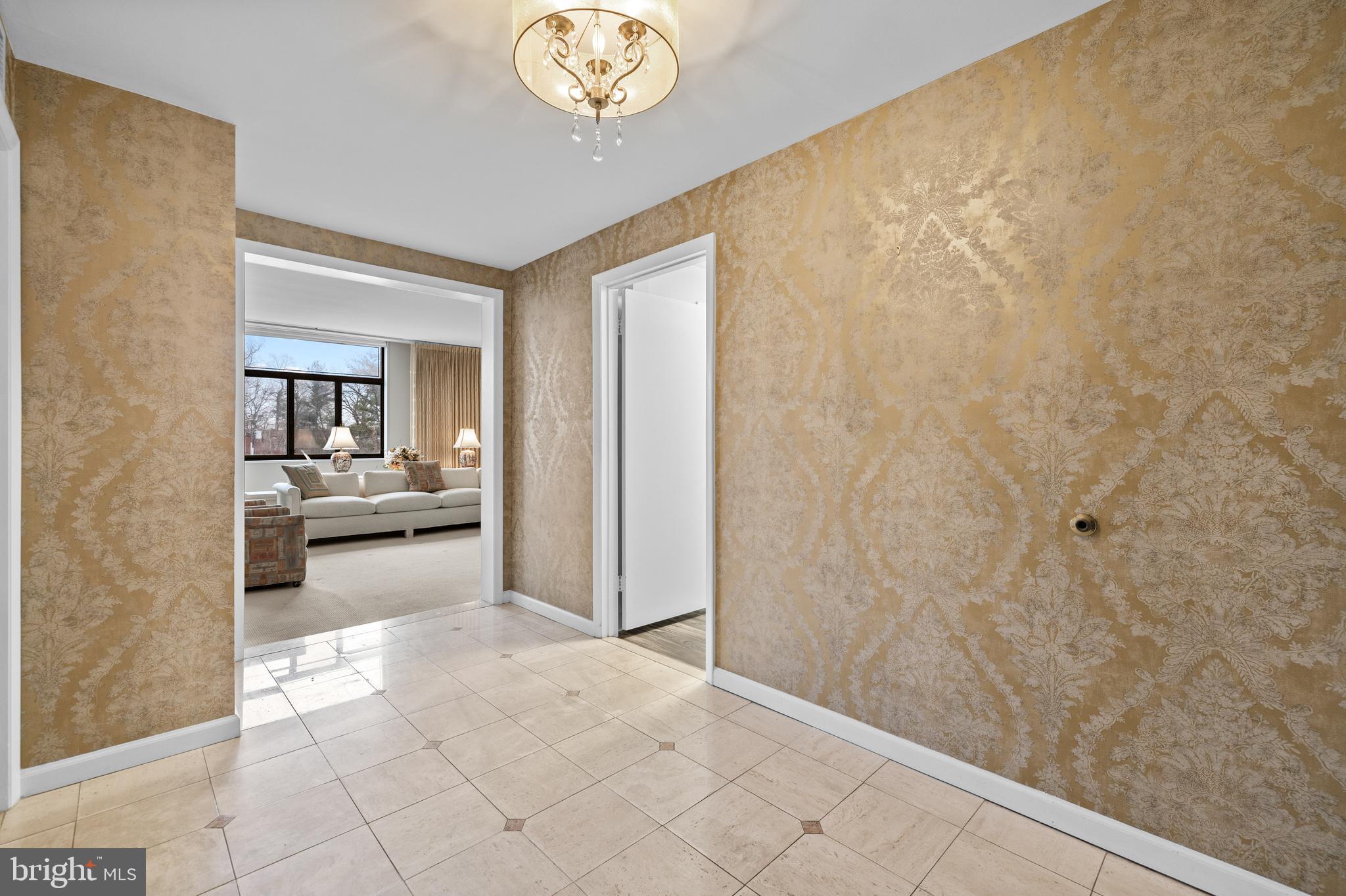 1 Slade Avenue, Unit 304 Baltimore, MD 21208 - Photo 11 of 44 a view of a hallway to a livingroom with furniture