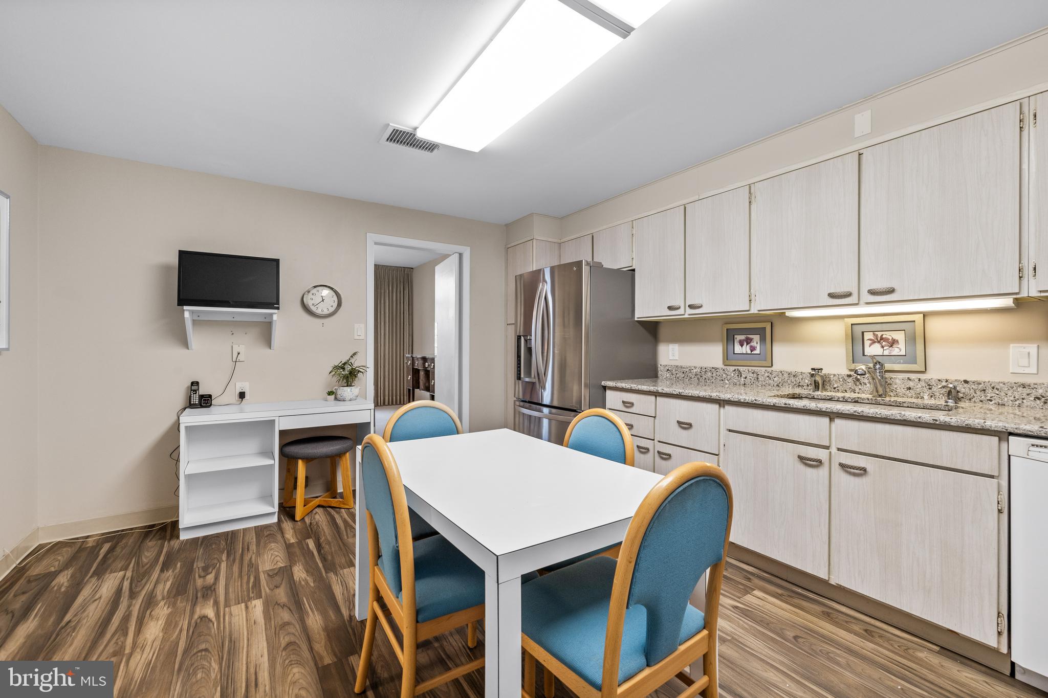 1 Slade Avenue, Unit 304 Baltimore, MD 21208 - Photo 14 of 44 a kitchen that has a cabinets counter space and appliances