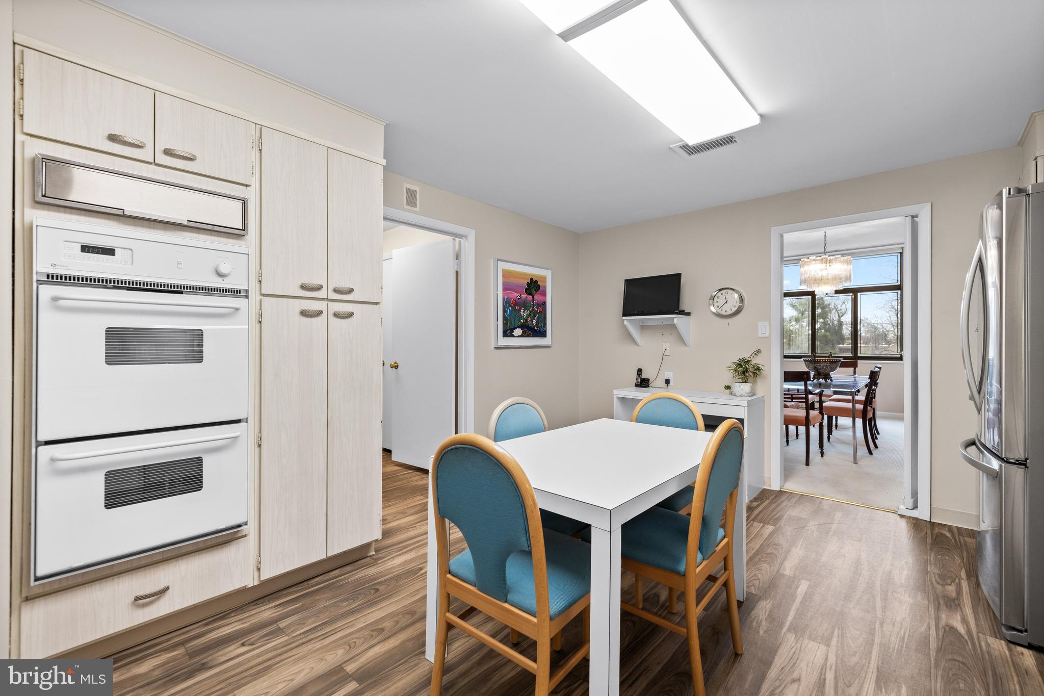 1 Slade Avenue, Unit 304 Baltimore, MD 21208 - Photo 15 of 44 a view of a dining room with furniture and wooden floor