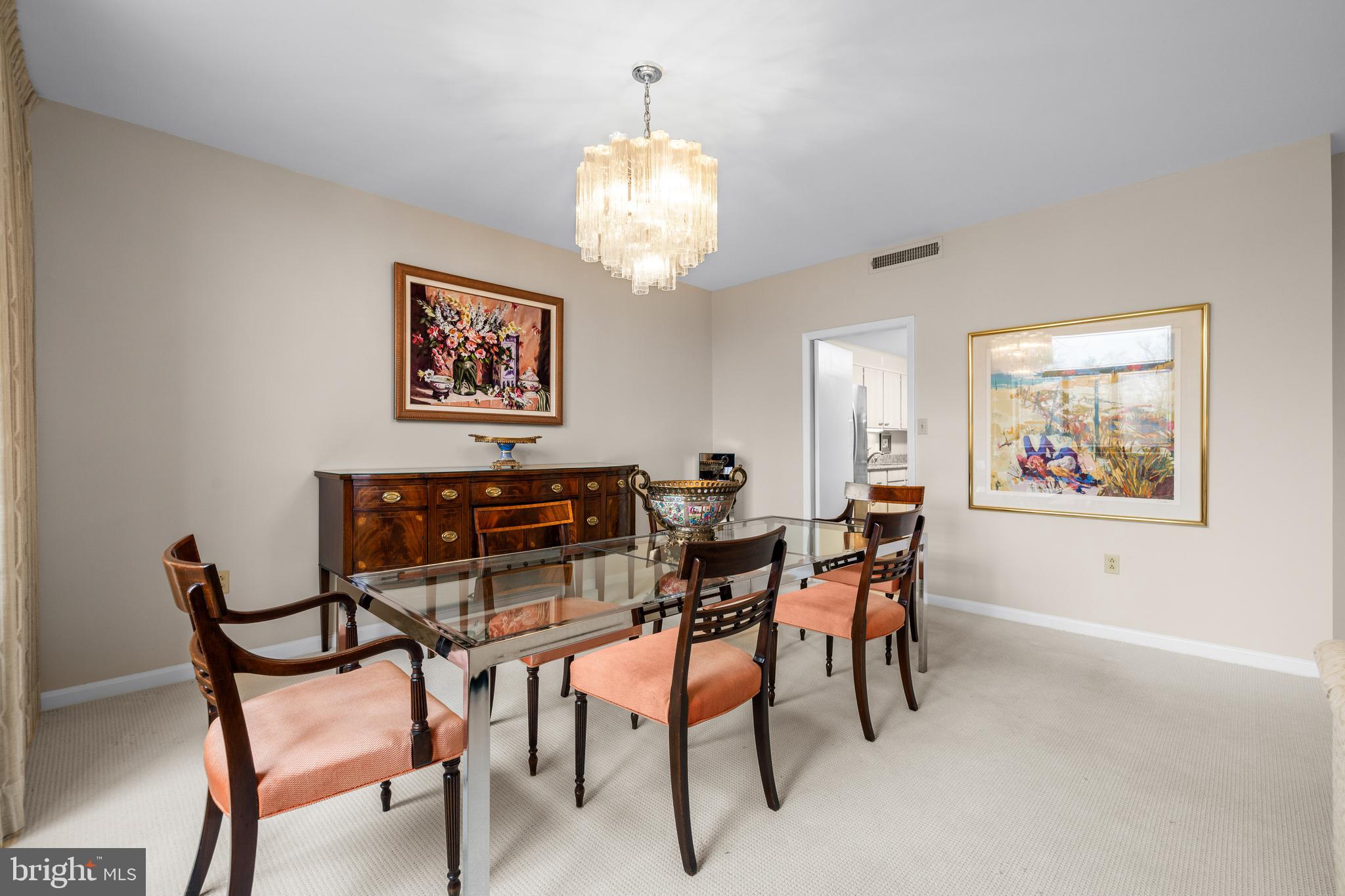1 Slade Avenue, Unit 304 Baltimore, MD 21208 - Photo 19 of 44 a view of a dining room with furniture and a chandelier