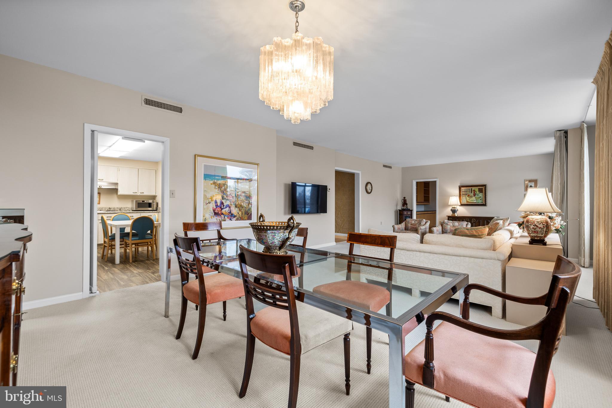 1 Slade Avenue, Unit 304 Baltimore, MD 21208 - Photo 20 of 44 a dining room with furniture a chandelier and window
