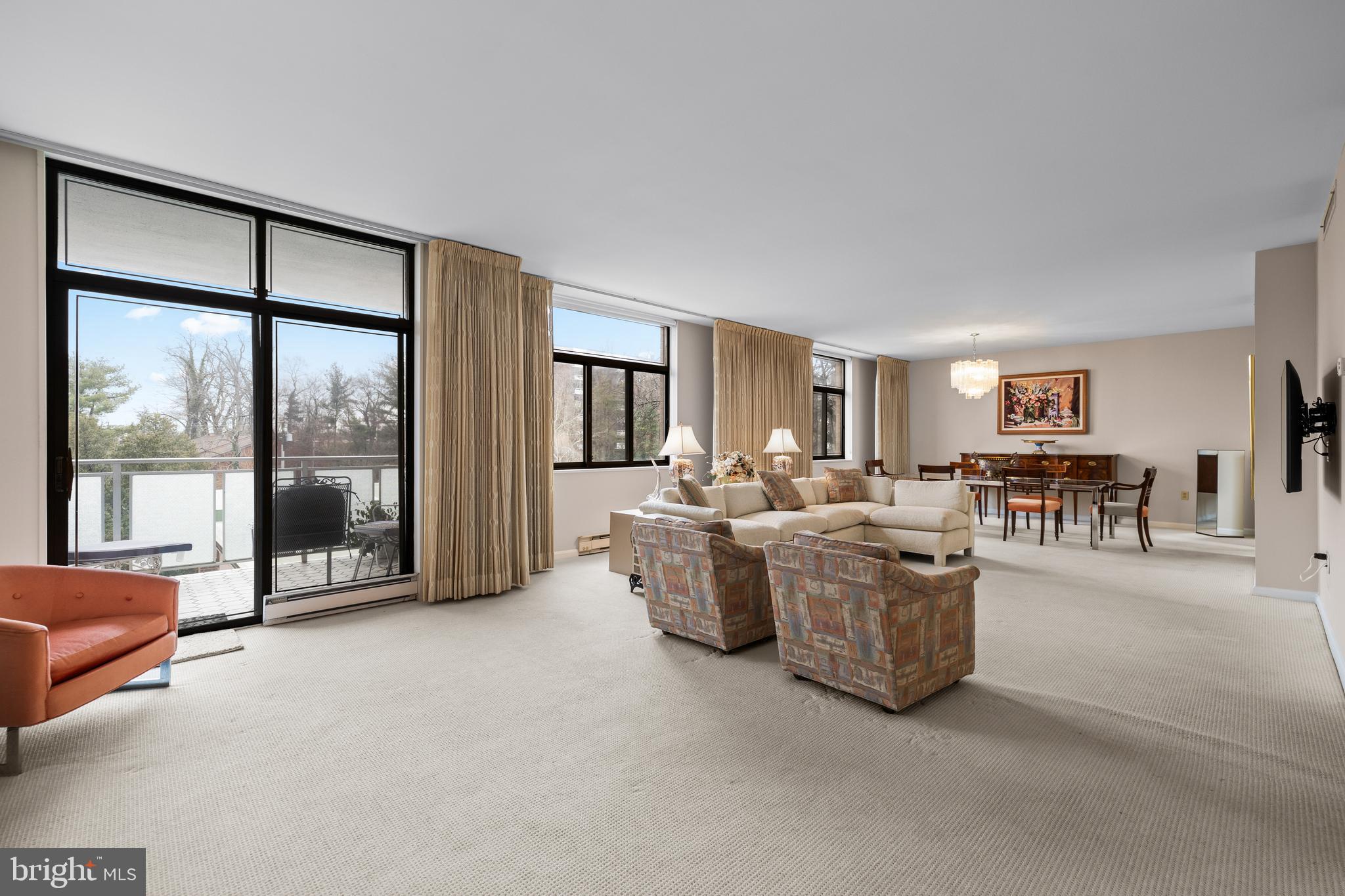 1 Slade Avenue, Unit 304 Baltimore, MD 21208 - Photo 23 of 44 a living room with couches and a large window with outer view