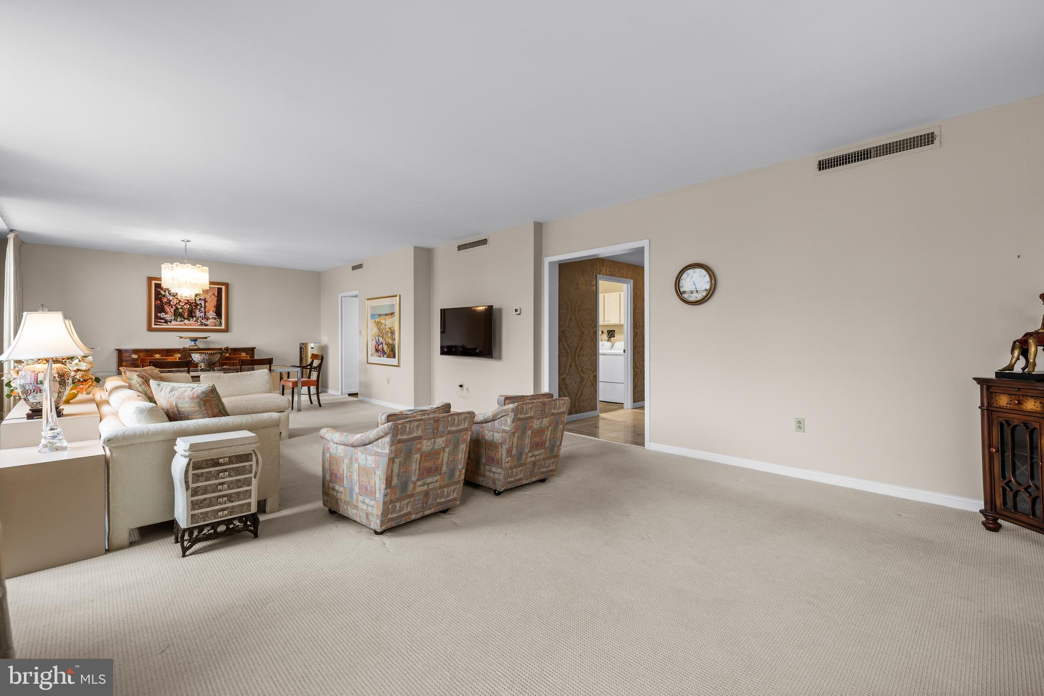 1 Slade Avenue, Unit 304 Baltimore, MD 21208 - Photo 24 of 44 a living room with couches and a flat screen tv
