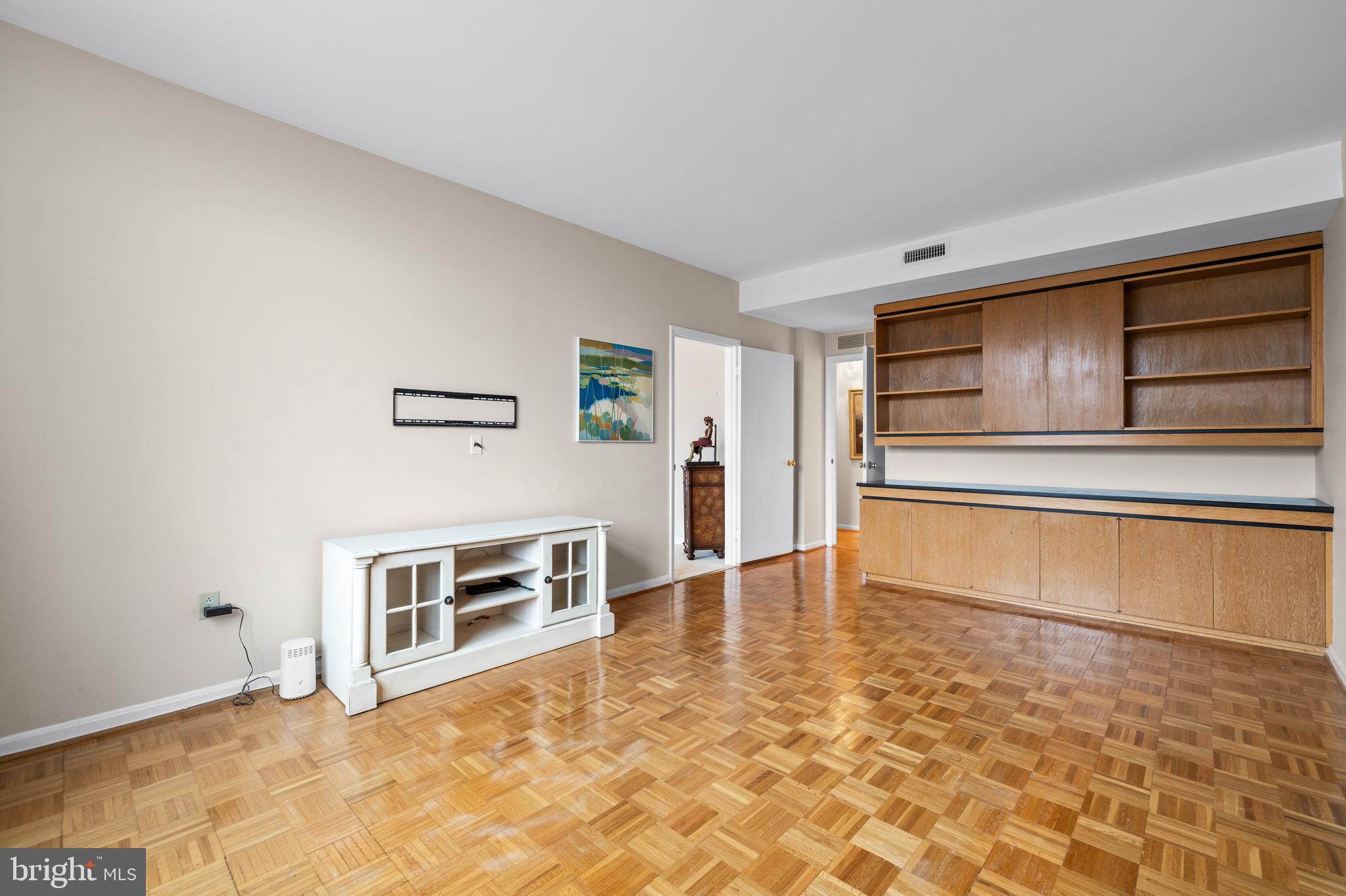 1 Slade Avenue, Unit 304 Baltimore, MD 21208 - Photo 29 of 44 a view of an empty room with kitchen and window