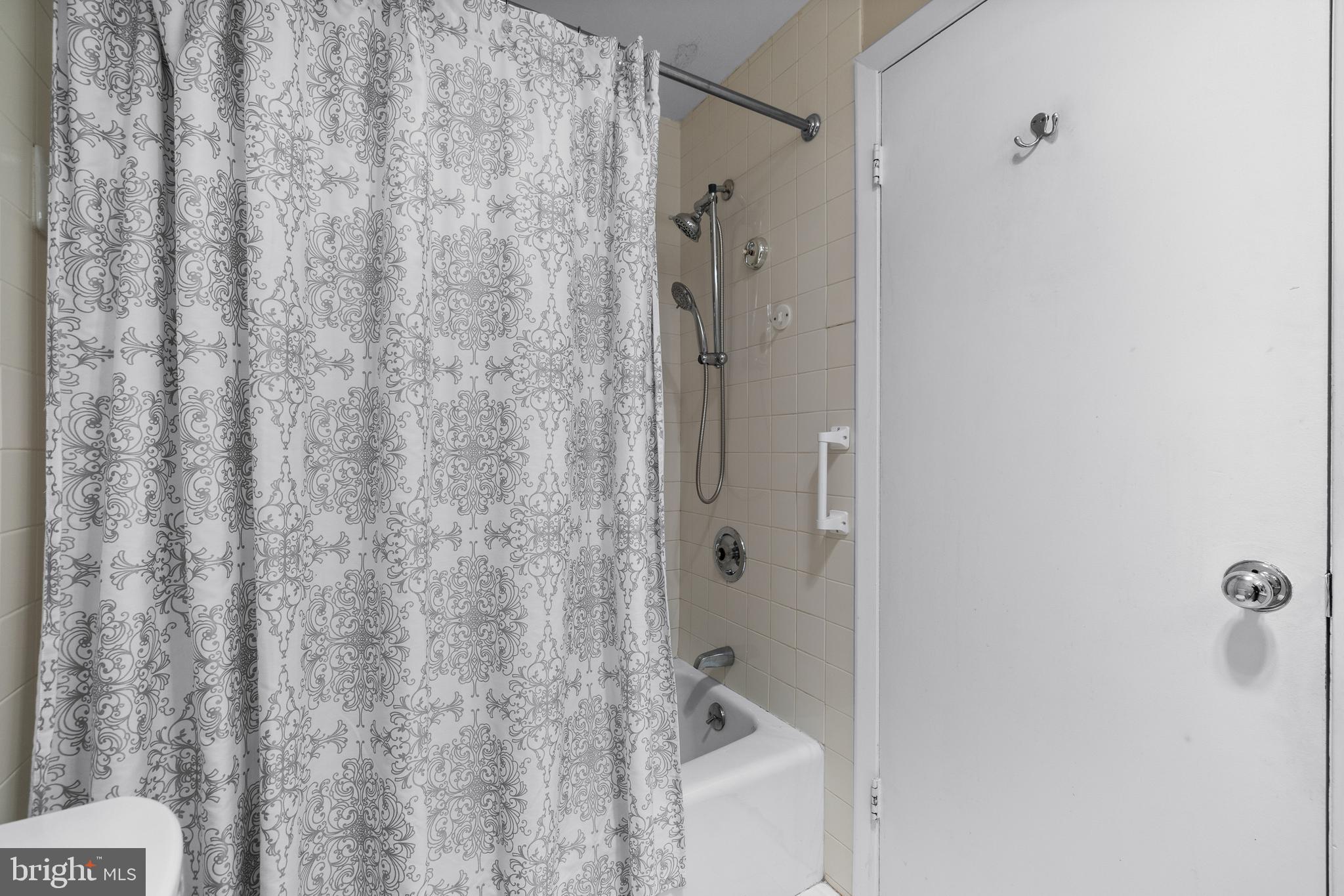 1 Slade Avenue, Unit 304 Baltimore, MD 21208 - Photo 32 of 44 a bathroom with a shower and a tub