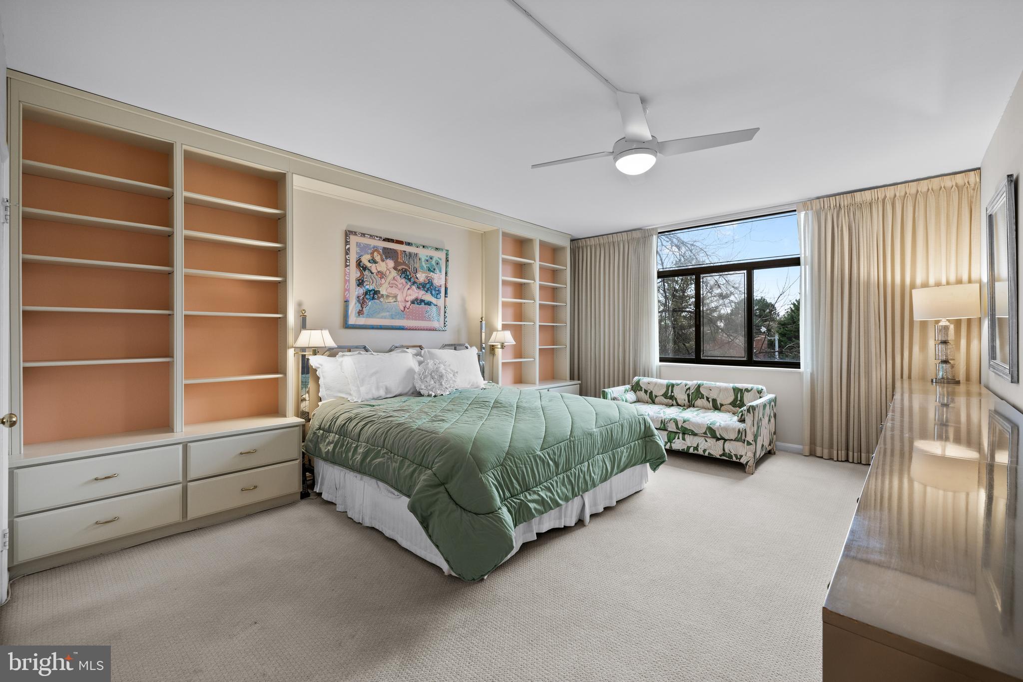 1 Slade Avenue, Unit 304 Baltimore, MD 21208 - Photo 33 of 44 a spacious bedroom with a bed and a couch